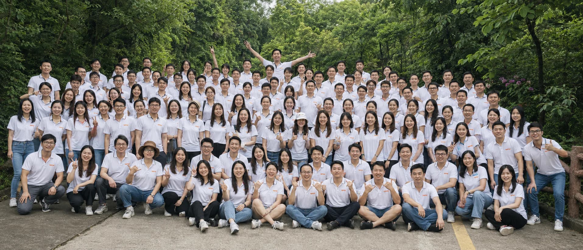 TOPTAI team in branded white shirts at a group event